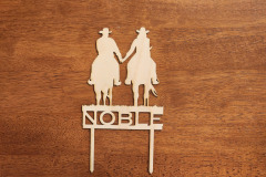 Baltic birch cake topper featuring couple riding off on horses